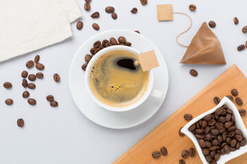 Cup of coffee on concrete background, top view