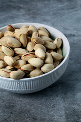 White bowl with unsalted pistachios