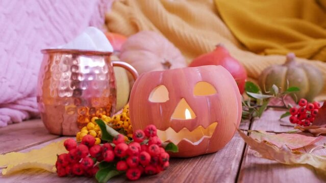 autumn Yellow Leaves, pumpkin, orange pyracantha Berries on table, Halloween preparation, Jack-o'-lantern candlelight, Autumn Decor and Creativity