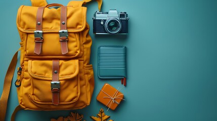 A top view of a backpack with a disposable camera, a travel journal, and a compact first aid kit, arranged in a circular pattern with clear copy space in the middle.