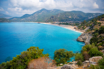 Aerial view of Oludeniz beach with people and boats in the morning, Coastline next to Fethiye, Turkey