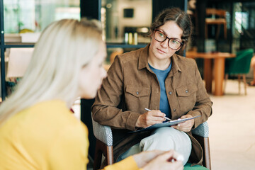 A female psychologist is counseling a depressed client. Working woman, professional specialist.