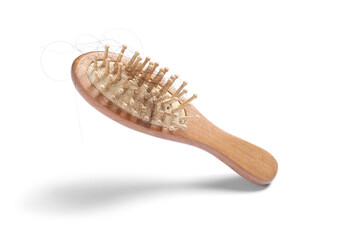 Brush with lost hair in air on white background