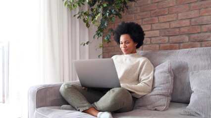 African American woman using her laptop at home