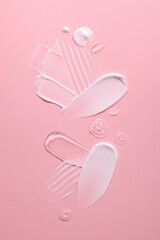 Samples of face cream on pink background, top view