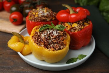Quinoa stuffed peppers with corn and basil on wooden table