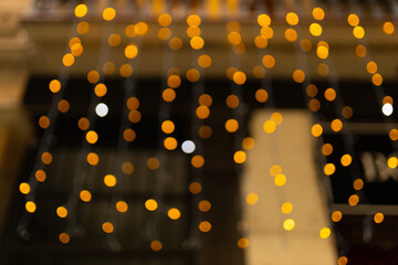 Decorative outdoor string lights at night time, Defocused Background, night city life backdrop,...