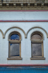 Vintage Abandoned Building with Red and Gold Facade.