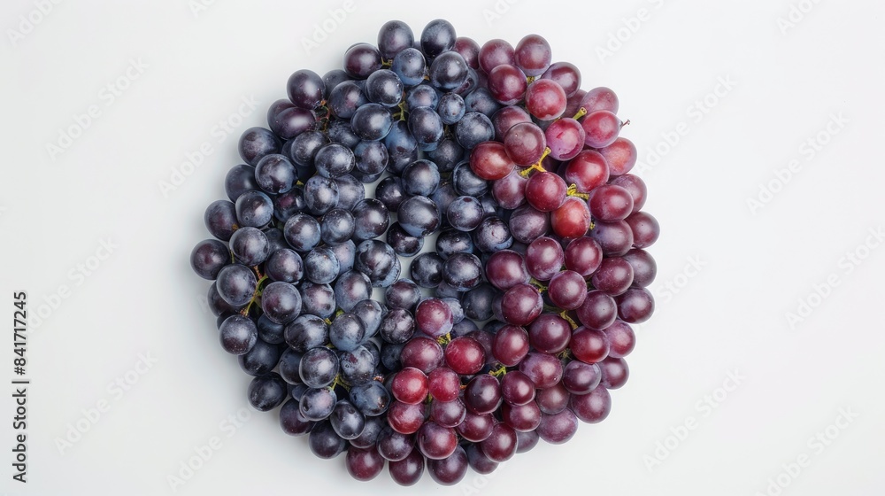 Poster grapes arranged in a circular pattern seen from above against a white backdrop