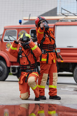 Firefighter Team Learning Thermal Camera Usage During Training Session