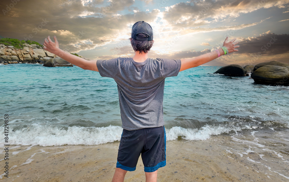 Wall mural young man happy to achieve glory on a beach