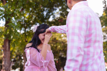 A young woman gives a mano po gesture as a sign of respect to her father. Filipino culture.