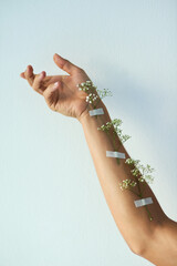 Space, skincare or hand with flower tape in studio for natural, sustainable or eco friendly...