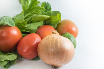 Indonesian typical vegetables and food ingredients: bok choy, tomatoes, key lime, onion; isolated on white
