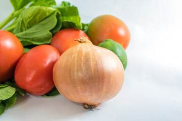 Indonesian typical vegetables and food ingredients: bok choy, tomatoes, key lime, onion; isolated on white