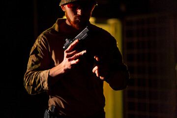 at a professional shooting range a military trainer reloading a pistol ready to shoot