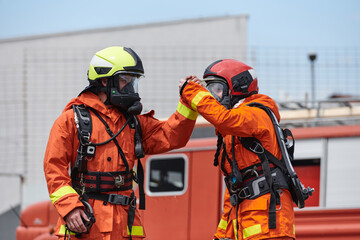 A unified team of firefighters, adorned in their uniforms, engages in a heartfelt celebration...