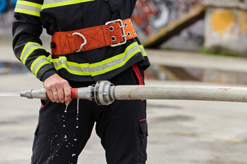 In a dynamic display of synchronized teamwork, firefighters hustle to carry, connect, and deploy...