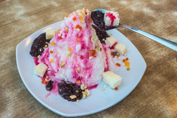 Indonesian traditional dessert; es campur (mixed ice); made from shaved ice, durian, syrup, chocolate, peanuts, breads, and sago patties