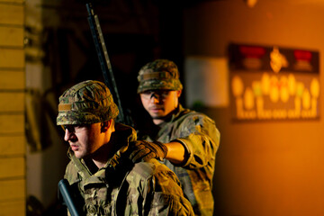at a professional shooting range military trainers perform tactical exercises with NATO assault...