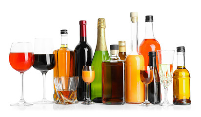 Bottles and glasses with different alcoholic drinks isolated on white