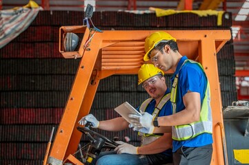 Two warehouse workers operate a forklift in a warehouse