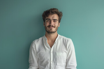 A close up portrait of a young man with a subtle smile