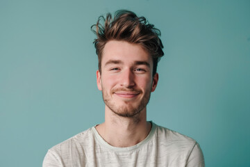 A close up portrait of a young man with a subtle smile