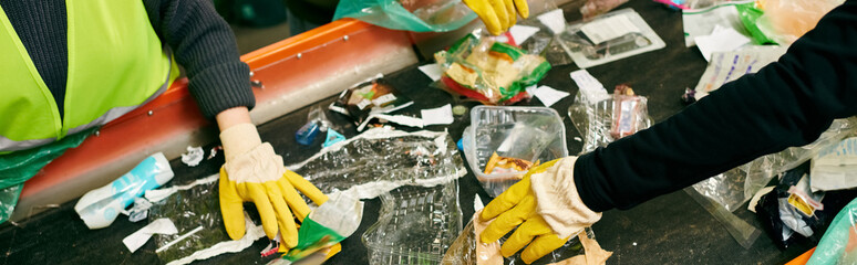 man in gloves sorting trash with other eco-conscious volunteers.