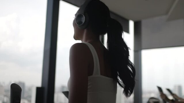 Pretty women are exercising at high rise building fitness center.