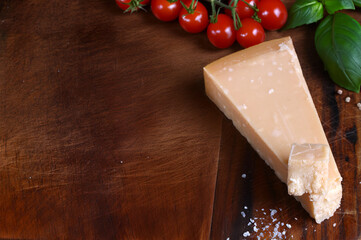 hard parmesan cheese on a wooden board