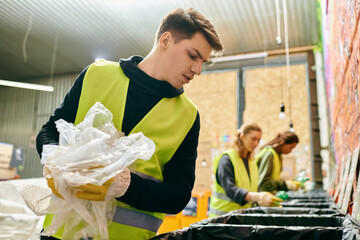 Young volunteer in yellow vest sorts trash into bin with eco-conscious team, making a positive...