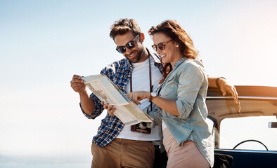 Check, couple and map outdoor for navigation, location search and destination for road trip. Happy people, man and woman with paper for guidance, direction and instructions for adventure journey