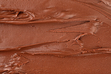 Melted chocolate cream as background, top view. Hazelnut cream, chocolate smear.