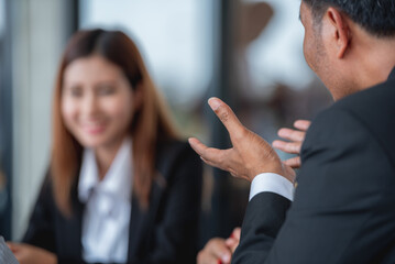 A man and a woman are having a business meeting in a restaurant.