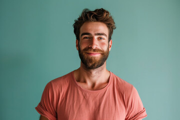 A close up portrait of a young man with a subtle smile