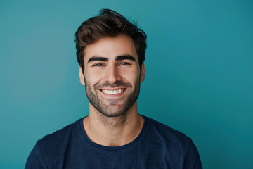 A close up portrait of a young man with a subtle smile