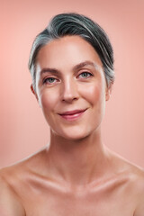 Beauty portrait, anti aging and senior woman with facial glow and natural makeup in studio. Skin...