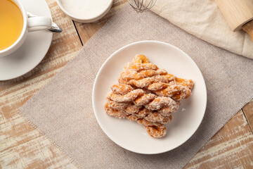Puffy Twist Donut,mildly sweet and fluffy,twisted sugar doughnuts in white plate.Top view