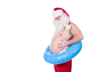 Vacations and holidays. Funny Santa Claus with an inflatable ring dreams of the sea. White...