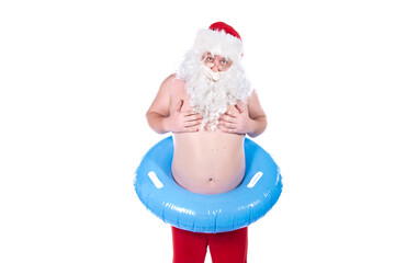 Vacations and holidays. Funny Santa Claus with an inflatable ring dreams of the sea. White background.
