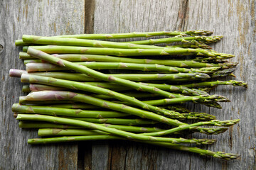 Asparagus, kitchen and diet on table for nutrition, lunch or product with wellness for health. Organic vegetable, cooking and above for benefit on counter, detox or meal prep for vegan food in home