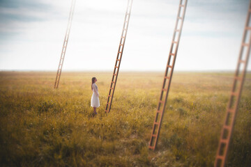 woman chooses a surreal ladder out of many that descend from the sky, business concept © Cristina Conti