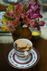 cup of coffee, cup of coffee and flowers, cup of tea and cookies