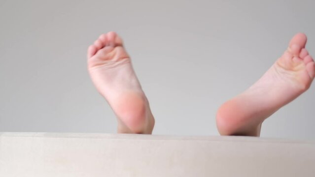 legs of a 9 year old boy having fun lying on the sofa