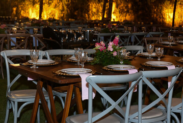 table set for a dinner, restaurant in the city, cafe in the city, restaurant in the night, restaurant tables and chairs, restaurant tables in the garden, hanging lights, christmas tree at night
