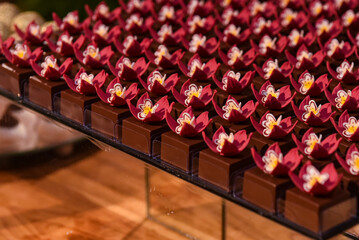 candles and flowers, chocolate in a box, fine chocolates, chocolate with flower, display with chocolate, candy store, chocolate shop, coffee shop, party sweets
