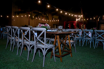 table set for a dinner, restaurant in the city, cafe in the city, restaurant in the night, restaurant tables and chairs, restaurant tables in the garden, hanging lights, christmas tree at night
