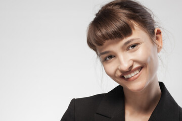 Young businesswoman smiling confidently in studio portrait