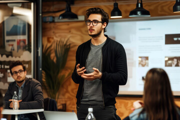 Entrepreneur presents a pitch to investors in a modern office, engaging with gestures.